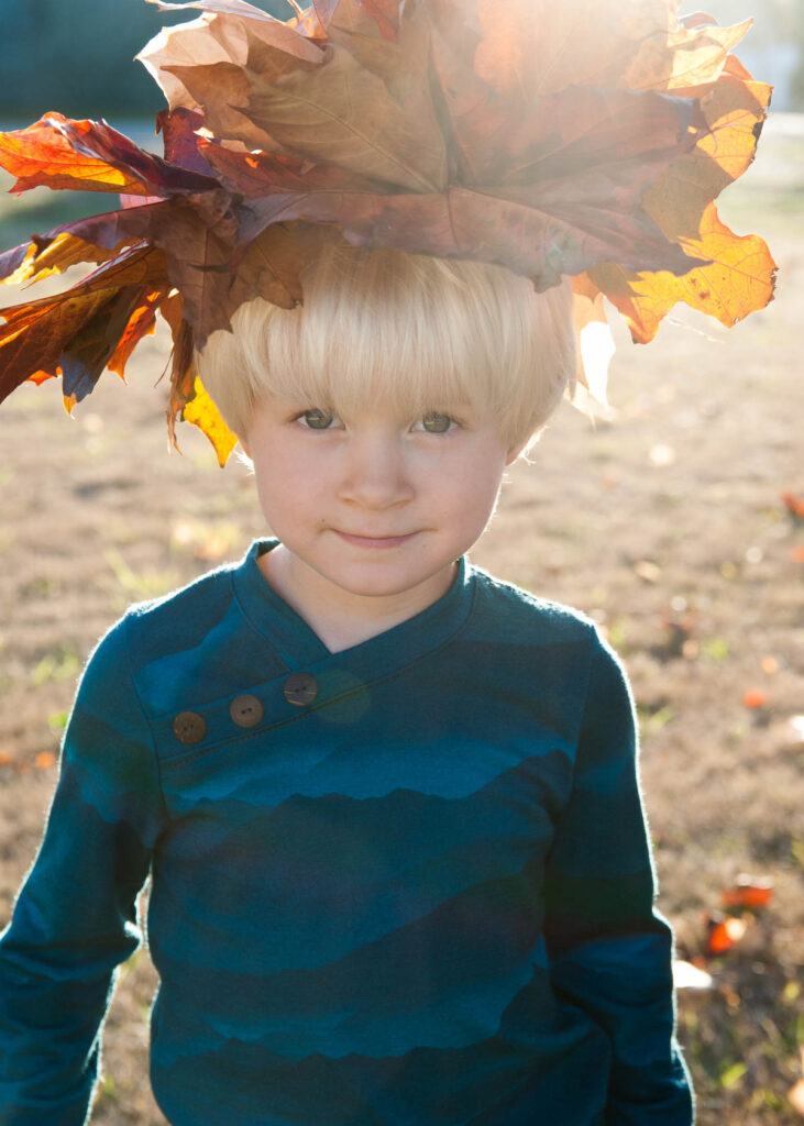 a boy wearing a handmade merino wool longsleeve shirt