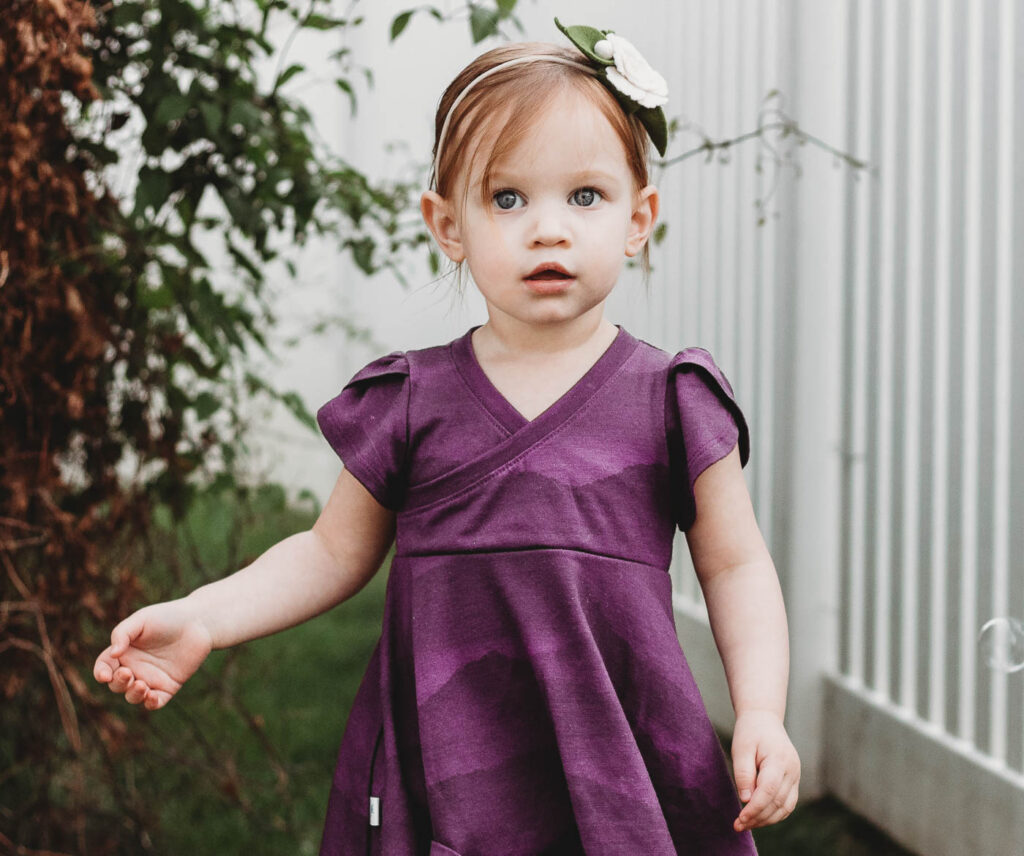 a girl wearing a handmade purple merino wool dress