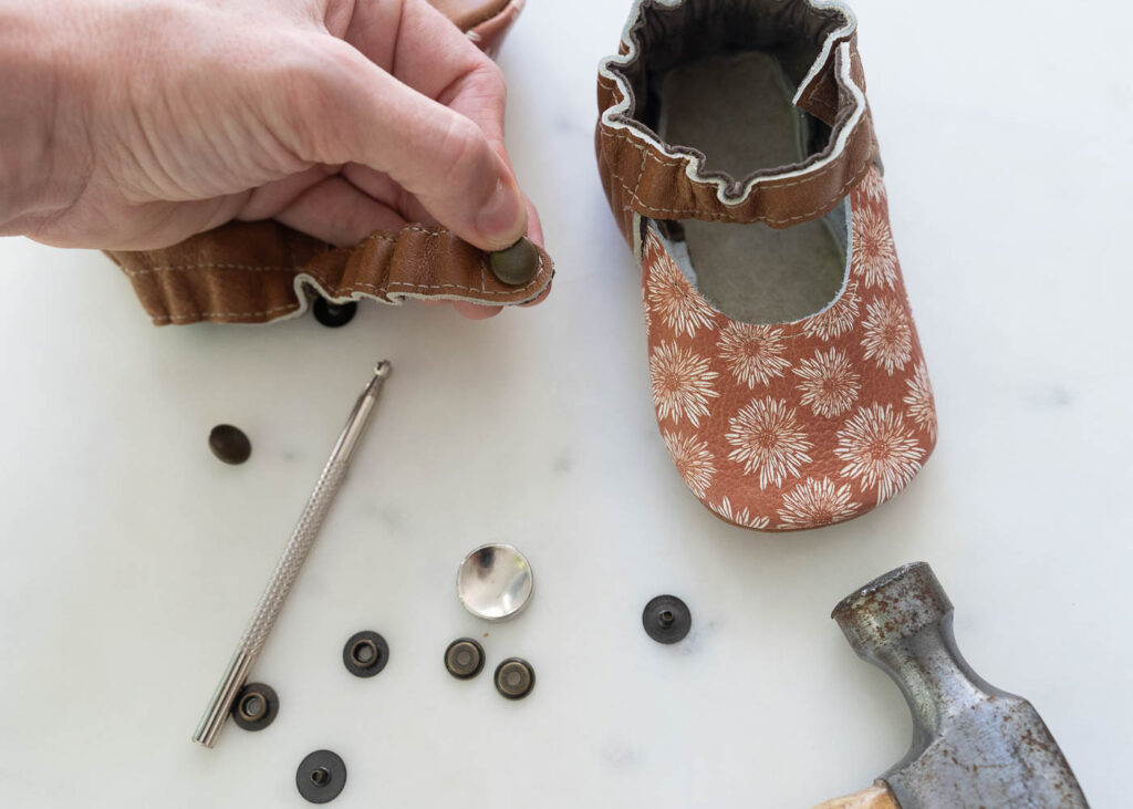 applying snaps to leather baby shoes