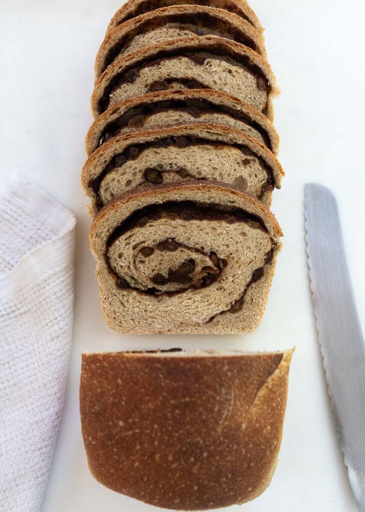 A sliced loaf of sourdough cinnamon swirl bread