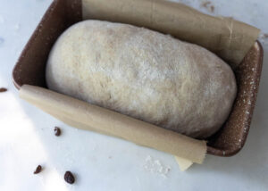a loaf of sourdough cinnamon swirl bread ready to be baked