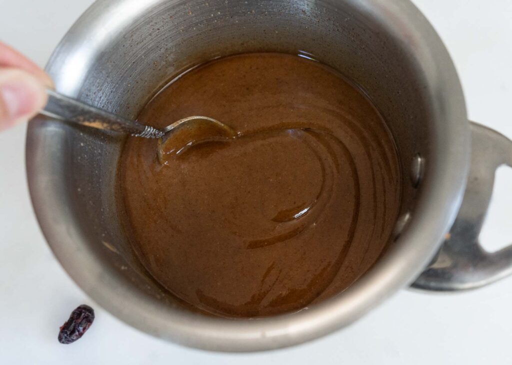 almond butter and coconut oil in a saucepan for making healthy homemade granola bars
