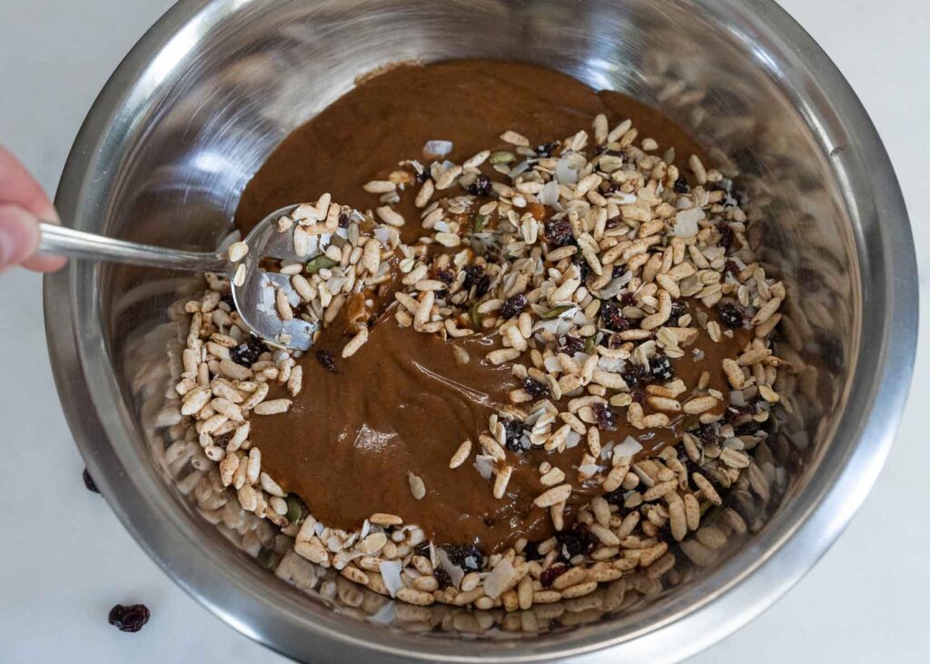 a mixing bowl with ingredients for healthy homemade granola bars