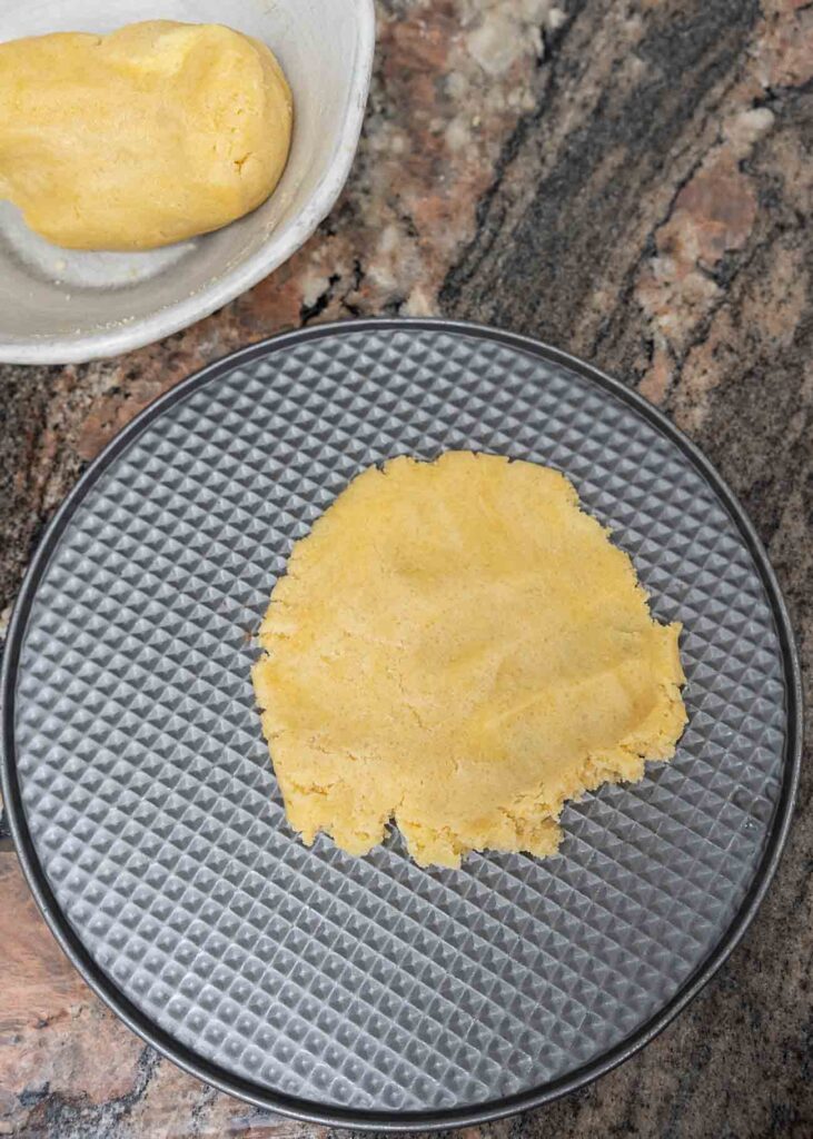 pressing cheesecake crust on a springform pan
