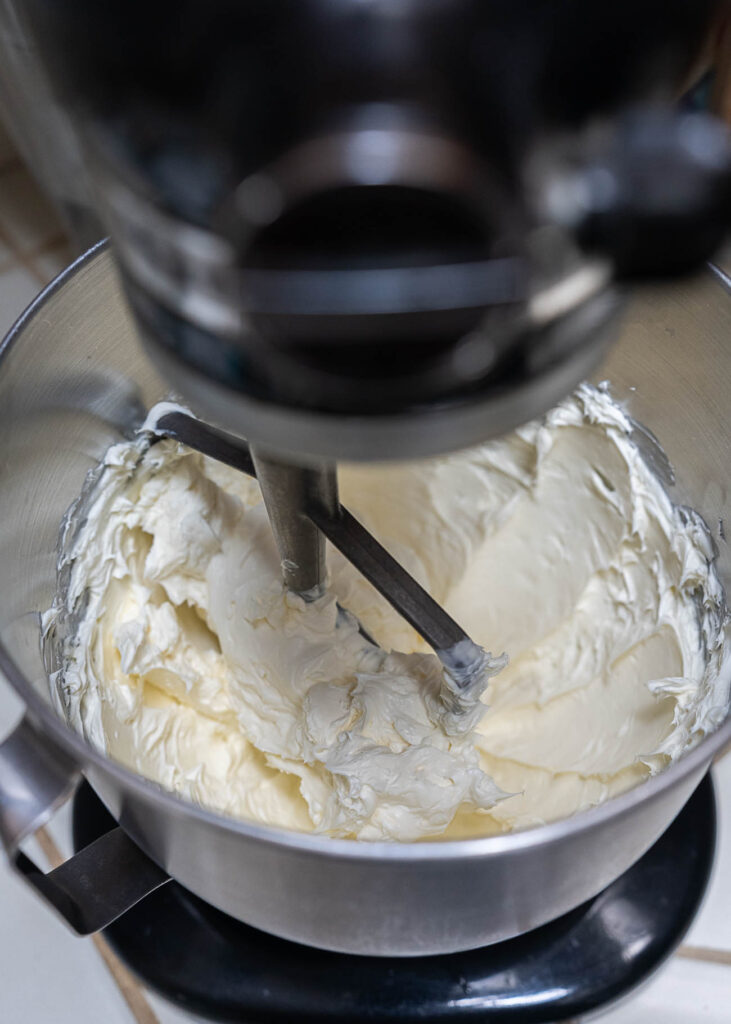 mixing cream cheese for cheesecake