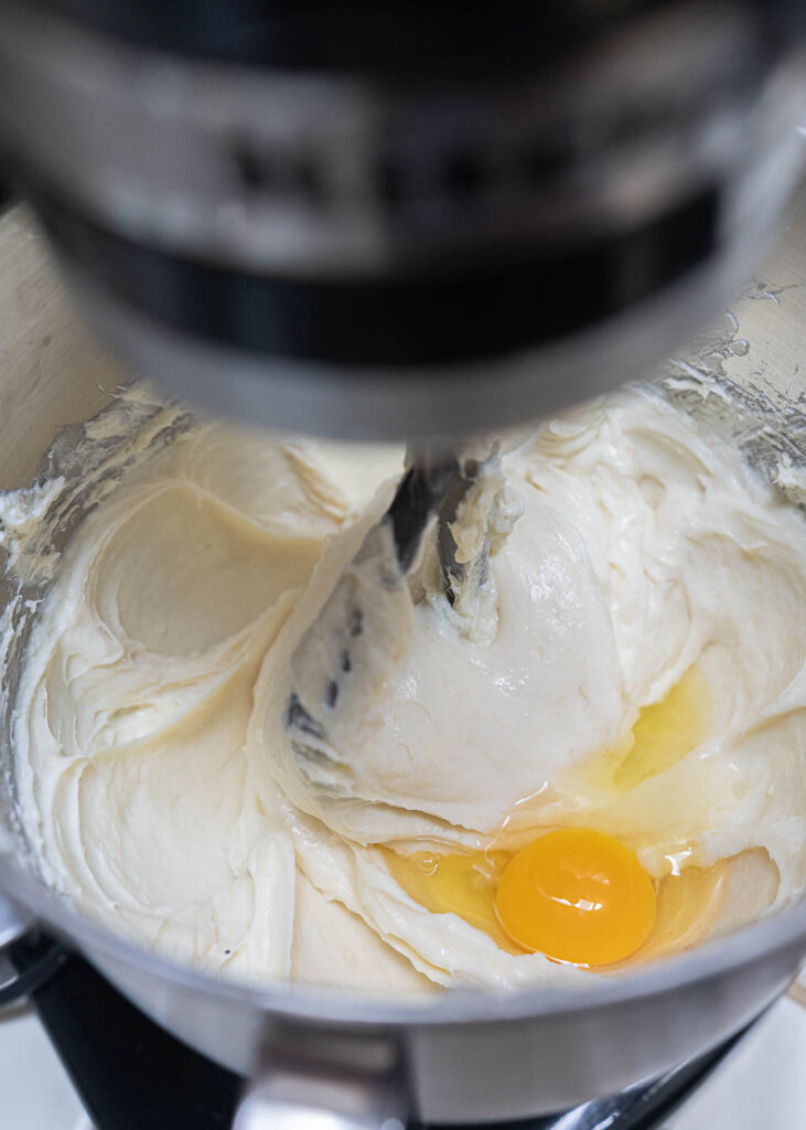 a mixer with cheesecake batter