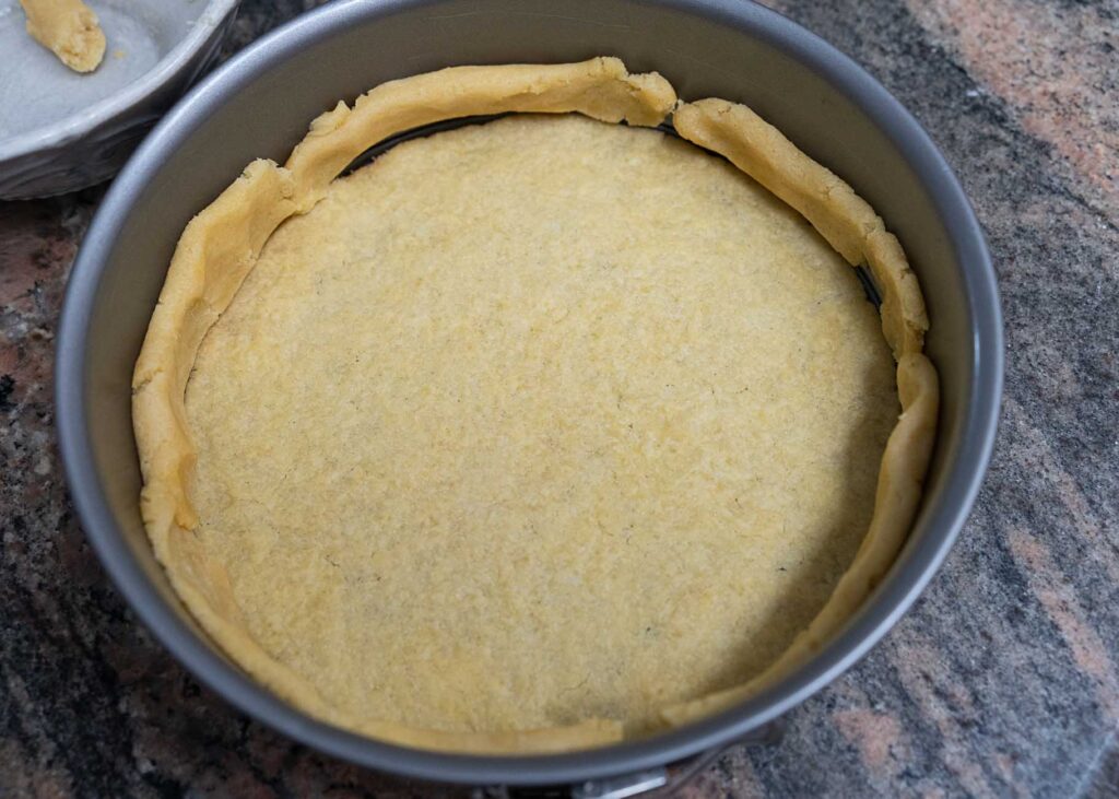 homemade cheesecake crust in a springform pan
